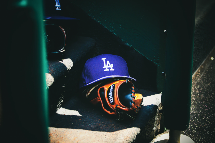 LA Dodgers hat on a baseball mitt. 