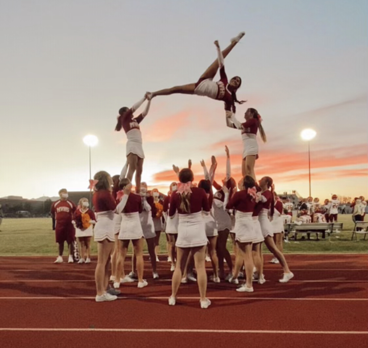 MVHS Cheer team performing a stunt.