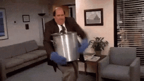 Kevin from The Office holding his pot of chili.